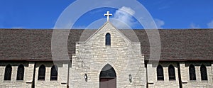 Stained Glass Windows and Cross on Church Steeple of Old Christian Stone Temple