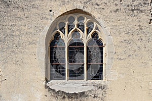 Stained-glass windows decorate the facade of a church in Occagnes (France)
