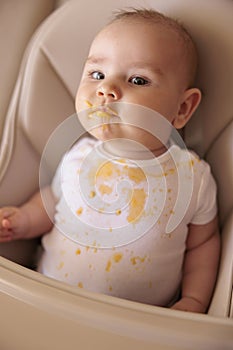 Stained messy baby boy refuses food