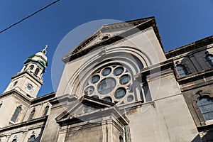 Stained stone exterior of an old church, elaborate rose window, beautiful architectural details