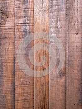 A stained wooden fence with lapped planks