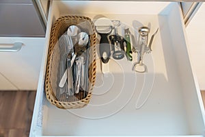 Stainless Forks, Spoons and wine bottle opener in apartment or Home. Kitchenware, dinnerware, lifestyle domestic concept