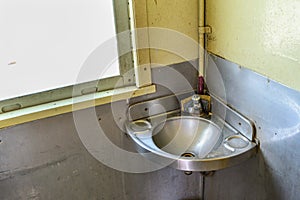 Stainless handbasin on train photo