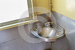 Stainless handbasin on train photo