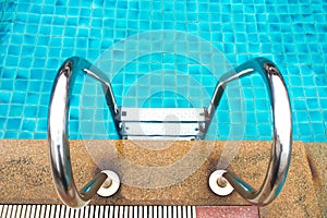Stainless ladder of swimming pool. Outdoor background.