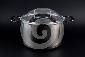 Stainless pan on a black background