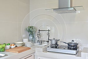 Stainless pan on gas stove with utensil in modern kitchen at home
