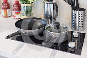 Stainless pot and pan with induction electric hob.