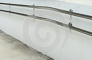 Stainless railing on white wall