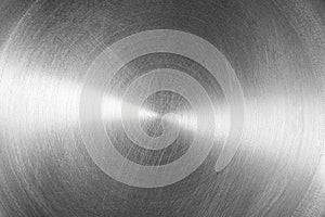 Stainless steel or aluminium circular brushed shiny metal texture. Abstract metallic background. Circle shape.