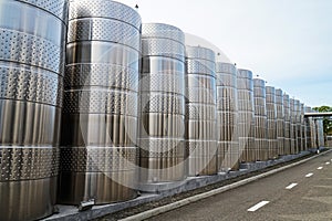 Stainless steel barrels for storing grapes for wine.