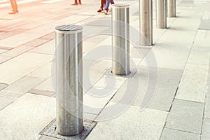 Stainless steel bollard entering pedestrian area on Vienna city street. Car and vehicle traffic access control