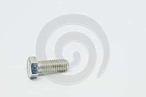 Stainless steel bolt on white background and selective focus