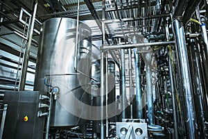 Stainless steel brewing equipment : large reservoirs or tanks and pipes in modern beer factory. Brewery production