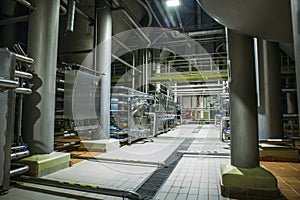 Stainless steel brewing equipment : large reservoirs or tanks and pipes in modern beer factory. Brewery production