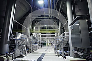 Stainless steel brewing equipment : large reservoirs or tanks and pipes in modern beer factory. Brewery production concept