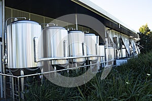 Stainless steel brewing vats or tanks.