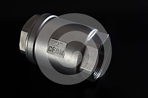 Stainless steel check valve on black background