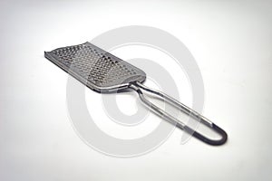 a stainless steel cheese grater isolated on a white background