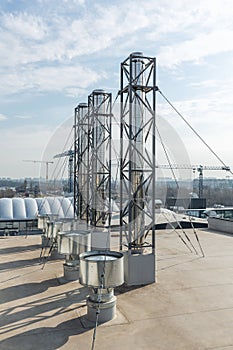 Stainless steel chimneys and baffles on the roof of the building