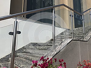 Stainless steel chrome plated finished hand rails with glass panels for an ramp or staircase steps for an building interiors for