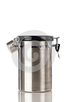 Stainless steel coffee ground container and scooper isolated on white background