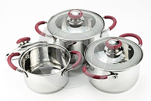Stainless steel cooking pots with lids isolated on white