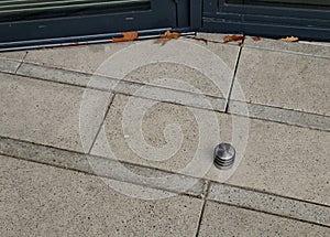 stainless steel door stop. concrete tile with rubber post in the shape of a