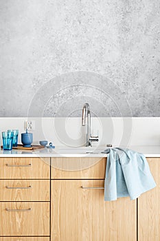 stainless steel faucet over kitchen sink in contemporary apartment