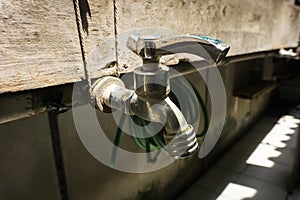 Stainless Steel faucet with water pipe line on a brick wall photo taken in Duri Tangerang Indonesia