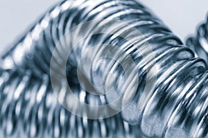 Stainless steel flexible hoses and flexi pipes, fittings and pressure joints close-up mackro. Industrial metal concept