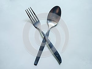 Stainless steel fork and spoon on white background