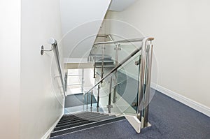 Stainless steel handrail and glass panels on staircase