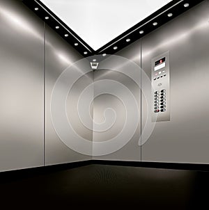 Stainless steel inside of elevator lift with corner camera,  buttons and lights