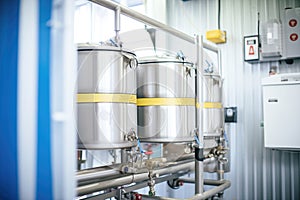 stainless steel kegs in an industrial-scale brewery refrigeration unit