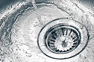 A stainless steel kitchen sink drain photo