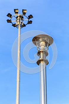 Stainless steel lamp pole at the road on blue sky