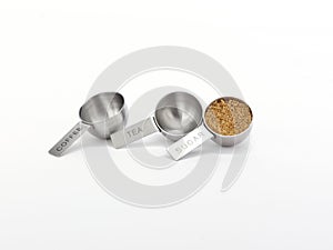 stainless steel measuring cups with brown sugar