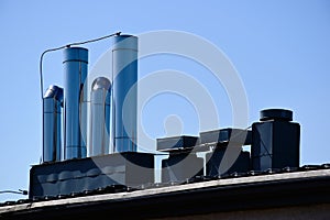 Stainless steel mechanical air vents on flat roof. blue sky and white cloud