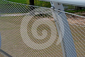 stainless steel mesh stretched on the bridge railing. the lower steel rope serves