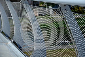 stainless steel mesh stretched on the bridge railing. the lower steel rope serves