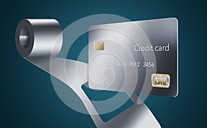 A stainless steel metal credit card is seen with a coil of sheet steel and you can see where the card has been punched out of the