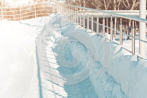 Stainless steel metal railings in snow winter. Manufacture of fences. Organization of pedestrian safety