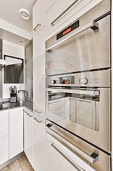 a stainless steel oven in a white kitchen