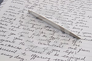 Stainless Steel Pen Laying on Written Page photo
