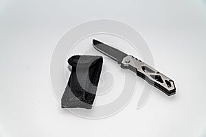 Stainless steel pocketknife with a black blade and a black case isolated on a white background