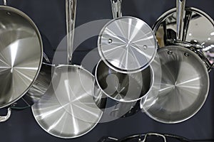 Stainless steel pots and pans hanging in the kitchen