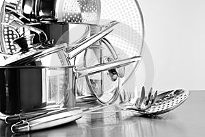 Stainless steel pots and untensils on table