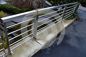 stainless steel railing on the concrete wall of the roof parking lot.