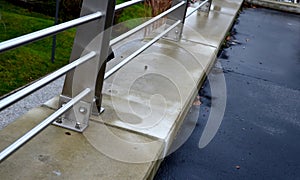 stainless steel railing on the concrete wall of the roof parking lot.